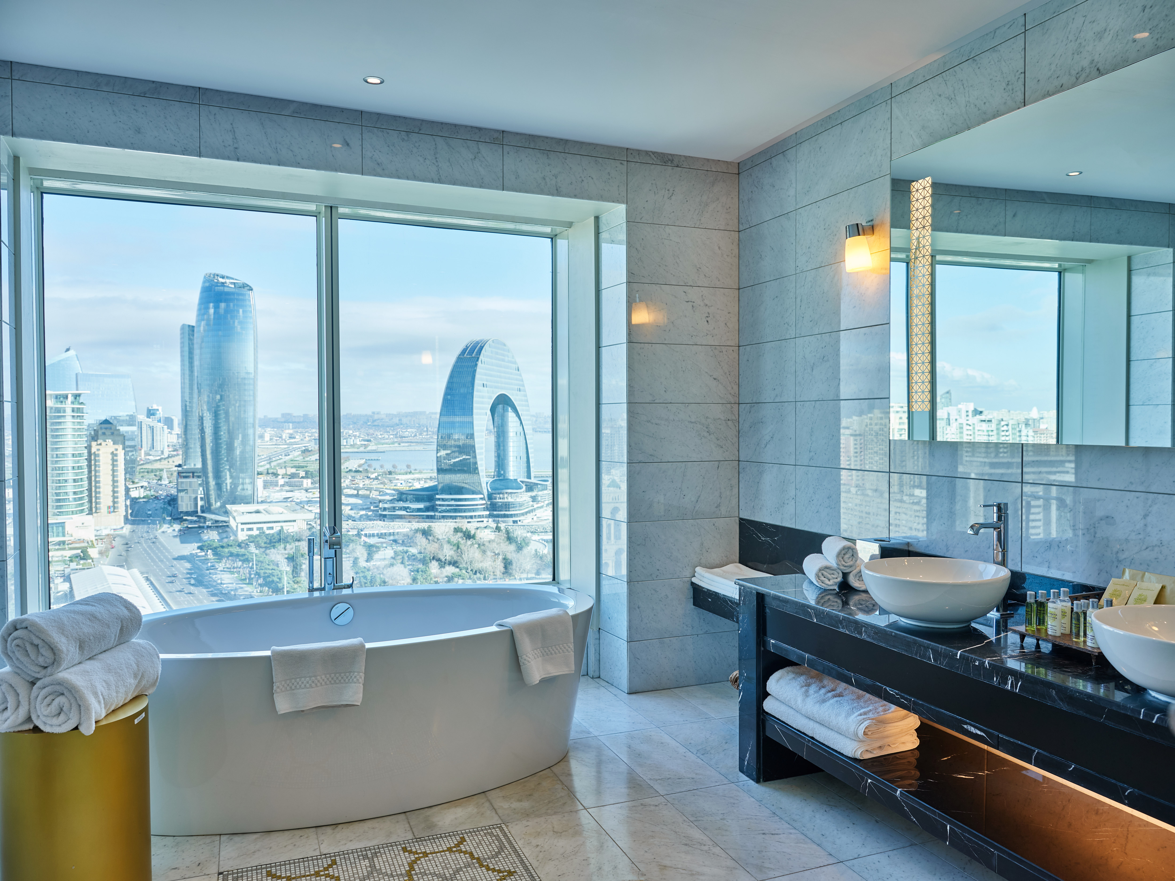 Suite Bathroom with Double Sink, Tub, and Skyline View 